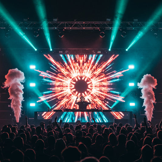 An EDM DJ performing live at a crowded music festival during nighttime