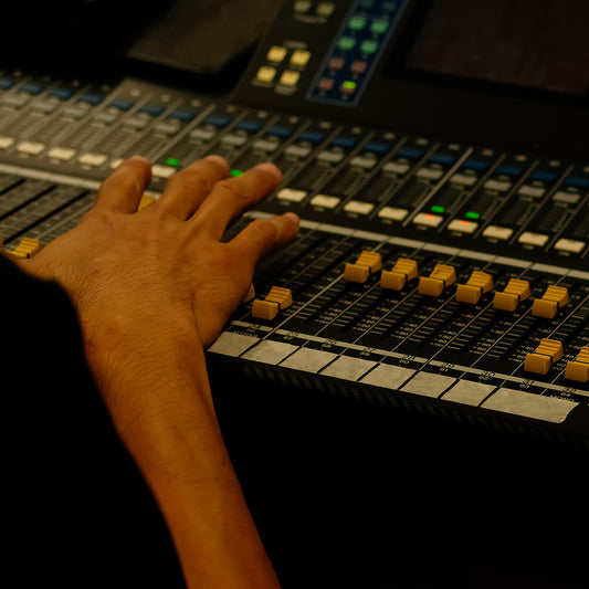 hand of sound engineer on the control panel