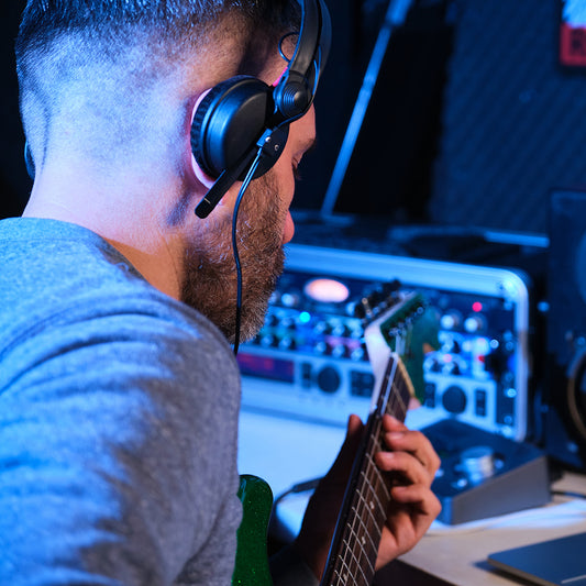 musician man playing electric guitar with headphone