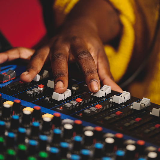 unrecognizable sound engineer working on mixing console blog feature