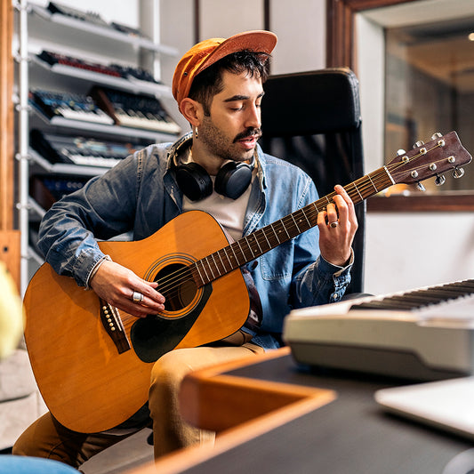 artist playing acoustic guitar