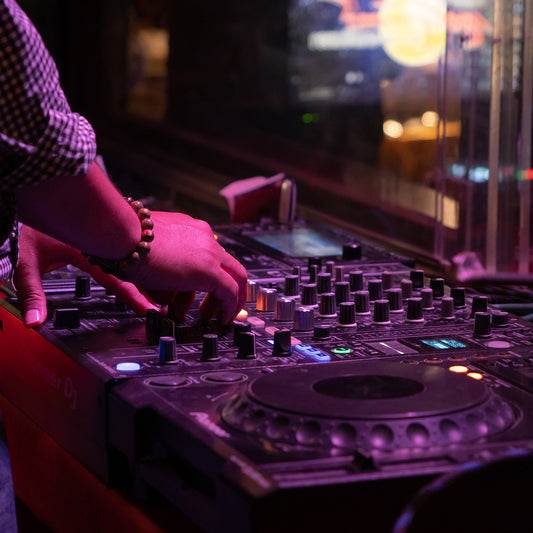 mixes on cd players or track at nightclub during party