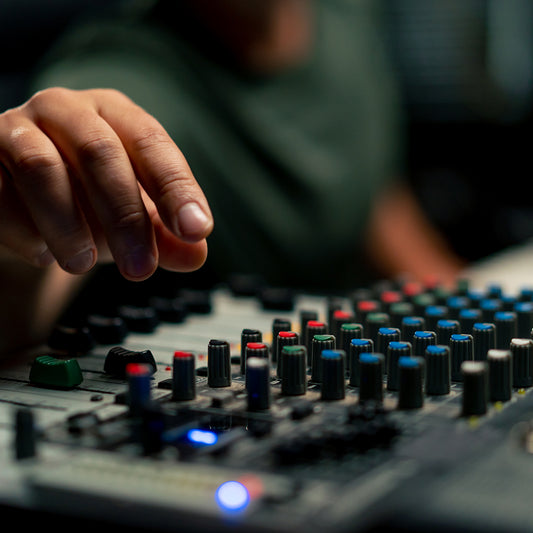 mixing console device used by a man working as a professional
