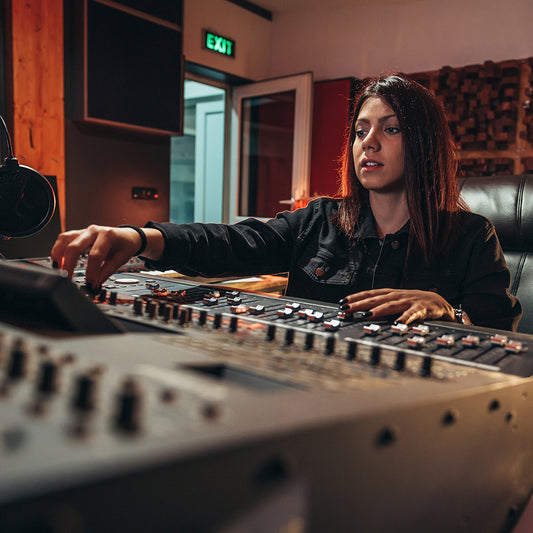 woman music producer working on a mixing soundboar blog feature