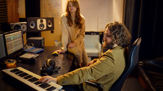 Mail producer and Female singer recording in studio